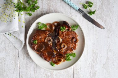 Pork on the bone in soy sauce with onions baked