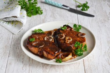 Pork on the bone in soy sauce with onions baked