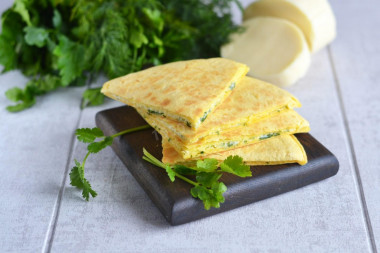 Tortilla with cheese and egg in a frying pan