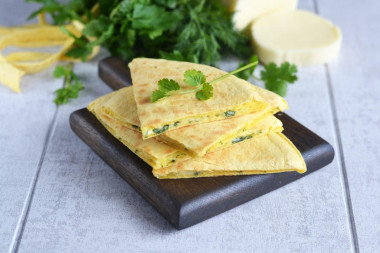 Tortilla with cheese and egg in a frying pan