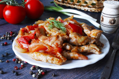 Pork with tomatoes in a frying pan