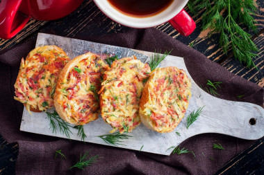 Sandwiches in a frying pan with sausage