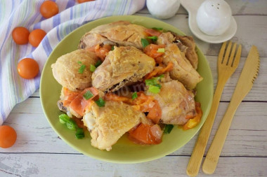 Chicken with tomatoes in a frying pan