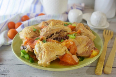 Chicken with tomatoes in a frying pan