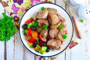 Pork shish kebab in a frying pan