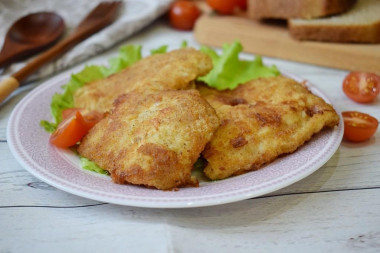 Pollock fillet in batter and breadcrumbs in a frying pan