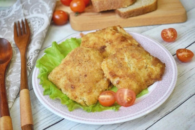 Pollock fillet in batter and breadcrumbs in a frying pan