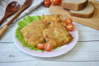 Pollock fillet in batter and breadcrumbs in a frying pan