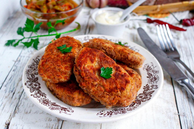 Minced beef patties in a frying pan