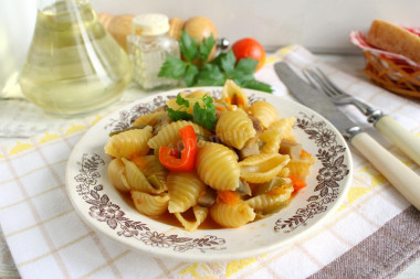 Pasta with mushrooms and vegetables in a frying pan