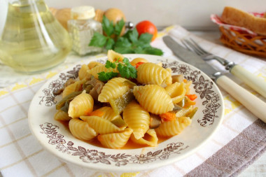 Pasta with mushrooms and vegetables in a frying pan