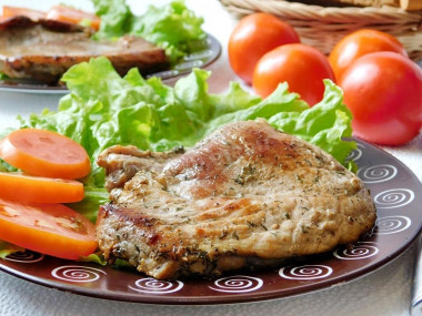 Pork steak with soy sauce in a frying pan