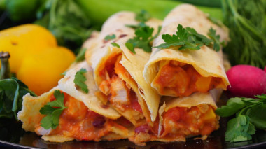 Burrito with chicken fillet, beans and tomatoes