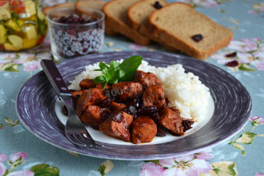 Pork goulash in a frying pan with cranberries