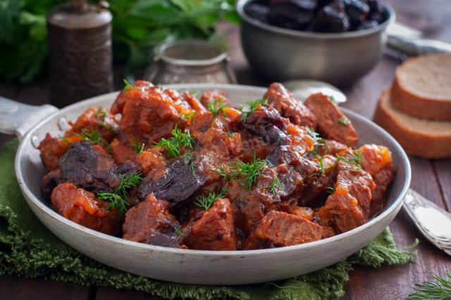 Beef with prunes in a frying pan