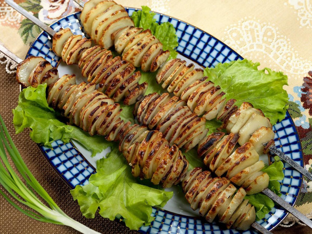 Young potatoes on skewers with lard, thyme and thyme