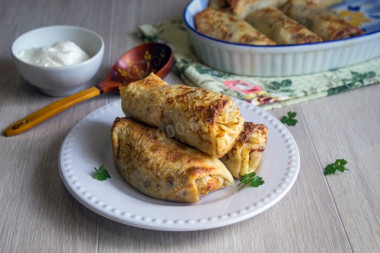 Pancakes made of dough on boiling water with potatoes and mushrooms in the oven