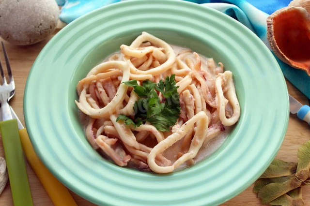 Squid in sauce with parsley on cream with spices