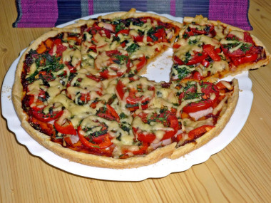 Pizza on liquid dough with pork, tomatoes and peppers