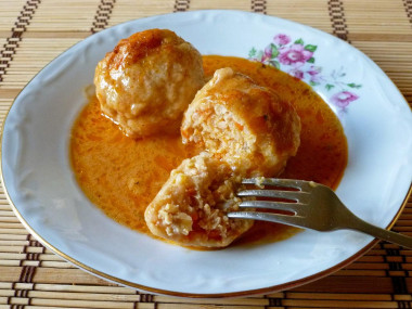 Pork meatballs in a saucepan with rice and gravy