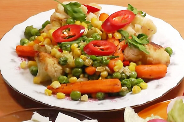 Frozen beans with corn and herbs in a frying pan