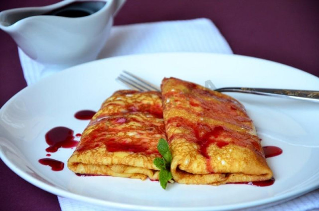 Pancakes stuffed with cherry sauce