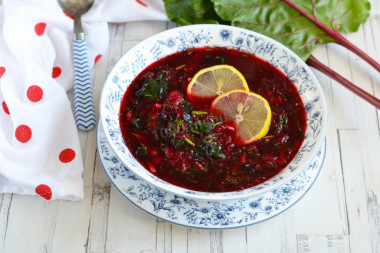 Classic cold borscht with boiled beetroot and tops