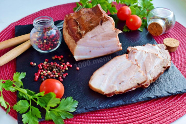 Pork belly in onion husks boiled in a saucepan