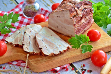 Pork belly in onion husks boiled in a saucepan