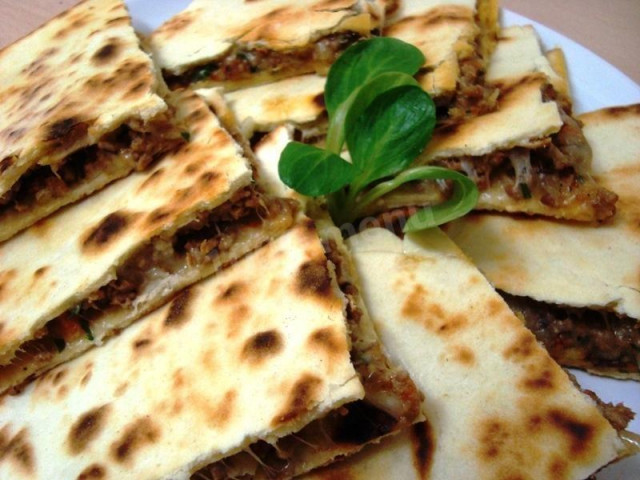 Mexican tortilla with meat in a frying pan