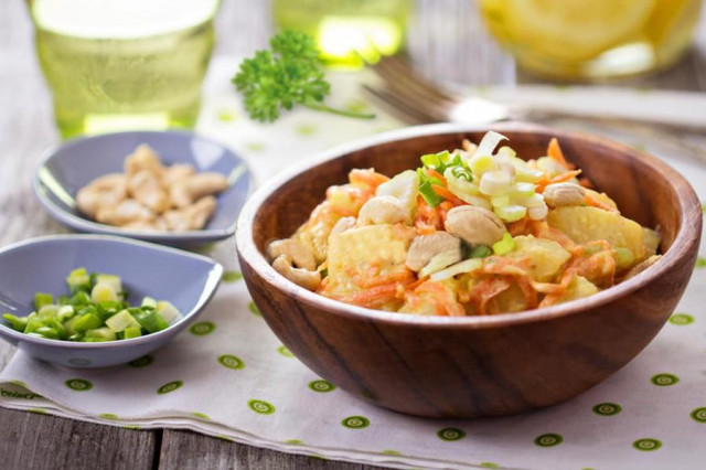 Salad with carrots, potatoes, celery and cashew stalks