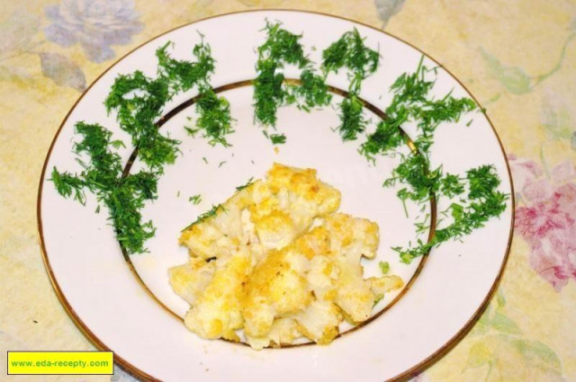 Fried cauliflower in breadcrumbs with egg in a frying pan