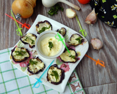 Eggplant in a pan with mayonnaise, fried with garlic