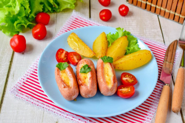 Fried sausages with cheese in a frying pan