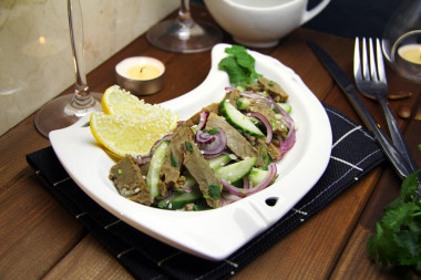 Salad with boiled beef, fresh cucumber and sesame seeds