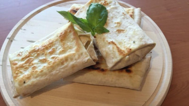 Envelopes of pita bread with tomatoes, mozzarella and basil