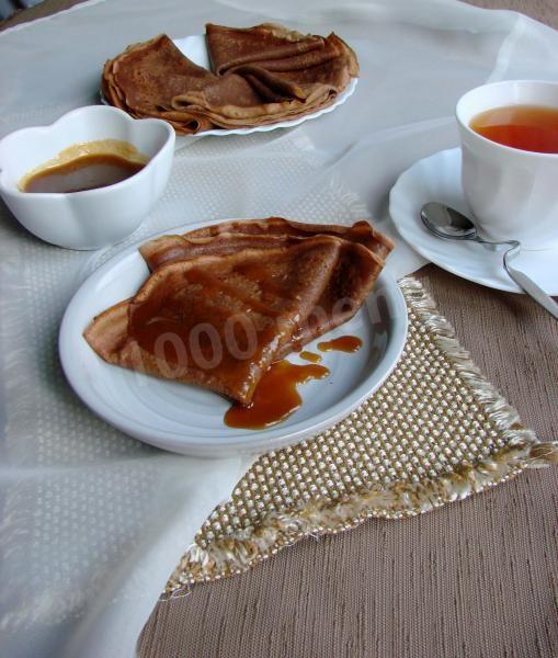 Chocolate pancakes with milk and water with chocolate and cocoa