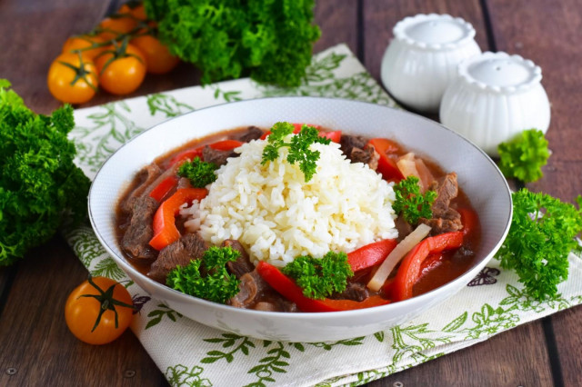 Rice with meat gravy in a frying pan