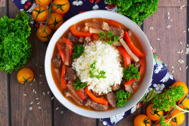 Rice with meat gravy in a frying pan