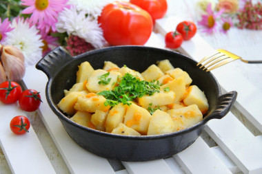 Stewed potatoes with carrots and onions in a frying pan