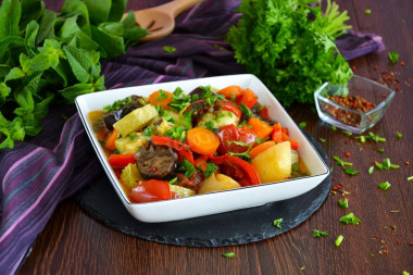 Stewed vegetables in a cauldron on the stove