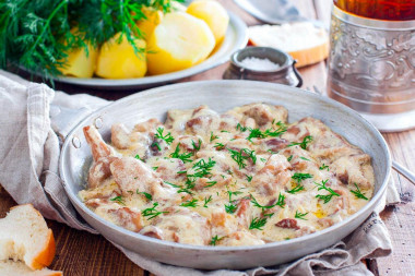 Mushrooms in sour cream sauce in a frying pan