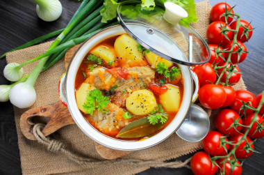 Stewed potatoes with pork ribs in a saucepan