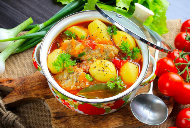 Stewed potatoes with pork ribs in a saucepan