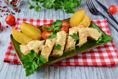 Chicken in cream sauce with cheese in a frying pan