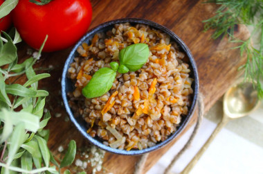 Buckwheat with onions and carrots in a pan