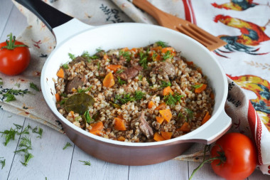 Buckwheat with stewed meat in a frying pan