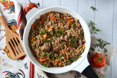 Buckwheat with stewed meat in a frying pan