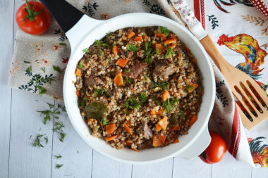 Buckwheat with stewed meat in a frying pan