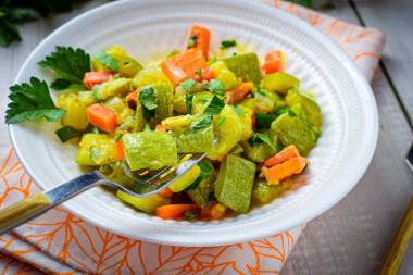 Stewed zucchini with carrots and onions